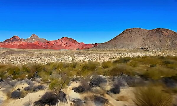 Dry Desert Landscape With Red Mountains