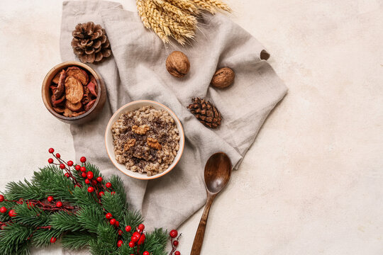 Bowl of traditional Ukrainian Kutya dish with Christmas wreath and pine cones on white background - Powered by Adobe