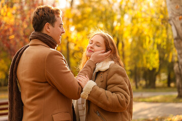 Beautiful loving young happy couple in autumn park