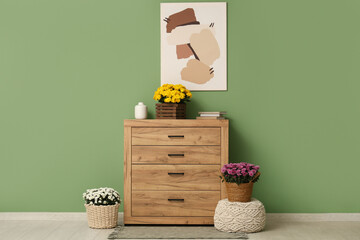 Interior of room with commode, painting and chrysanthemum flowers