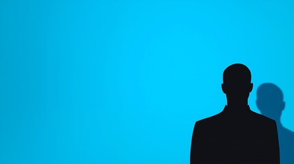 Silhouette of a Person Against a Blue Background