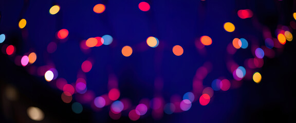 Naklejka premium A Christmas tree with lights is lit up and is on a dark background Ai Generated