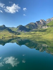 Fototapeta premium The alpine lake Melchsee or Melch Lake in the Uri Alps mountain massif, Kerns - Canton of Obwald, Switzerland (Kanton Obwalden, Schweiz)