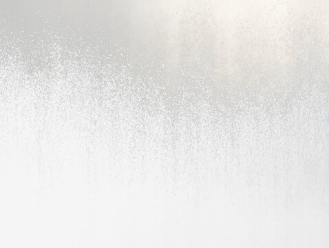 Abstract grayscale texture with a gradient from black to white, resembling sprayed paint or particles.