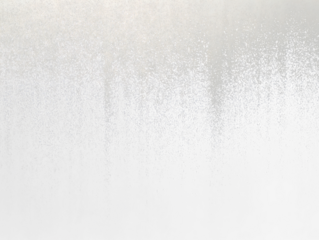 Abstract grayscale texture with gradient from white to black, resembling sprayed paint or dust.