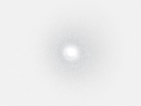 Bright central light surrounded by radiating particles in dark space.