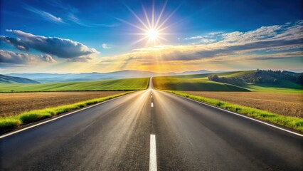 Asphalt road stretching towards a vibrant sunset over rolling green hills and a sunburst sky