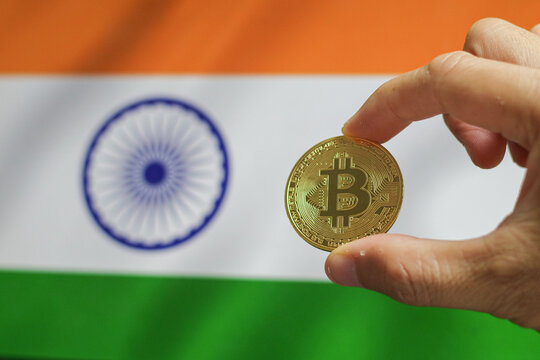 gold coin bitcoin on a background of a flag India