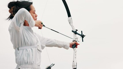 Archery, aim and girl with outdoor training, target practice and professional Japanese athlete. Bow, arrow and woman archer with sports challenge, shooting and precision performance at kyudo club