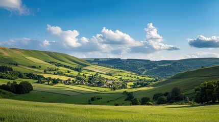 Naklejka premium Idyllic English Countryside Village Nestled in Rolling Green Hills Under a Blue Sky - Stunning Landscape Photography
