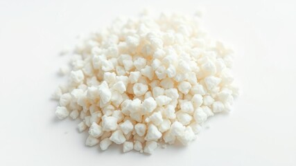 High magnification view of a handful of psyllium husk particles on white background, natural fiber, granules