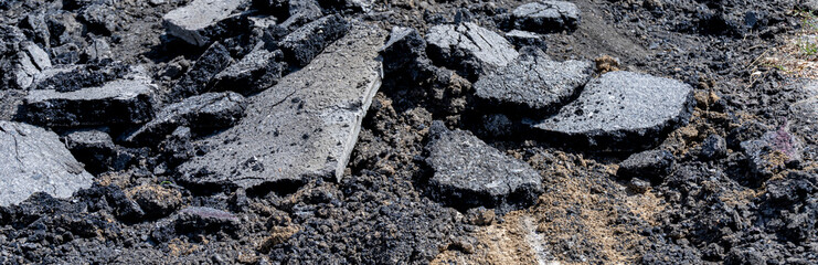 Natural black coal pile. Photograph of damaged asphalt road surface. Road maintenance. Stone. Transportation and communication. black asphalt texture. asphalt road. stone asphalt.