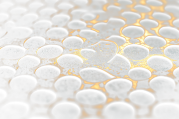 Close-up of a metallic surface with circular holes and a textured, aged appearance.
