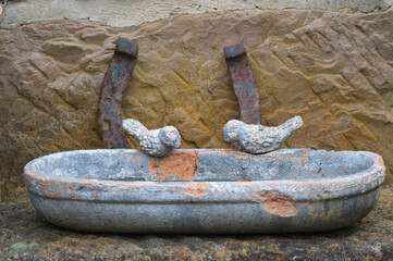 Outdoor view of an antique clay bird bath