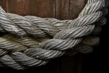 Close-Up of Braided Nautical Rope Wrapped Around Wooden Post