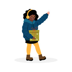 Young girl joyfully walks with a gift while wearing winter clothing and headphones