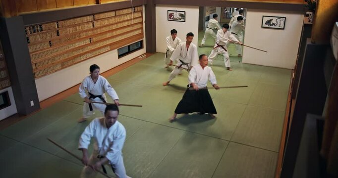 People, students and weapon for aikido, training and martial arts with fitness, kung fu and battle in Japan. Teaching, bokken and sensei for karate, fight and self defense class with exercise in dojo