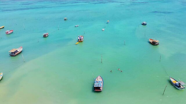 Charming view of S&atilde;o Jos&eacute; da Coroa Grande, Pernambuco, Brazil, with turquoise waters and boats anchored along the shore, creating a tranquil and tropical atmosphere.