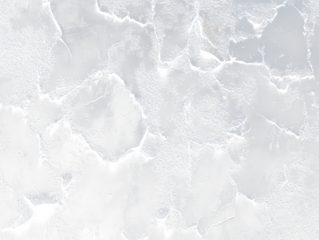 Close-up of dark, peeling paint on a textured surface.