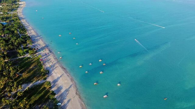 Twilight in Maragogi, Alagoas, Brazil, with turquoise waters reflecting the soft hues of the sky, creating a peaceful and magical atmosphere by the shore.