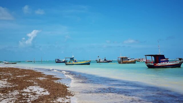 Peaceful scenery of S&atilde;o Jos&eacute; da Coroa Grande, Pernambuco, Brazil, with turquoise waters, golden sands, and boats gently floating. A tropical setting perfect for capturing serenity and natural beauty.