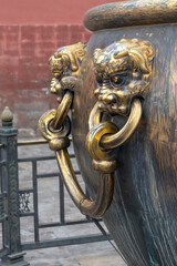Ancient bronze lions as a handle of vat in Forbidden City,