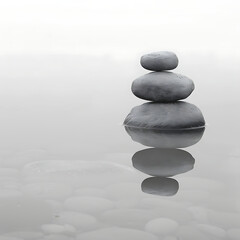 Tranquil Stacked Stones on Calm Water Surface Reflecting Serenity and Balance in a Minimalist Monochrome Landscape