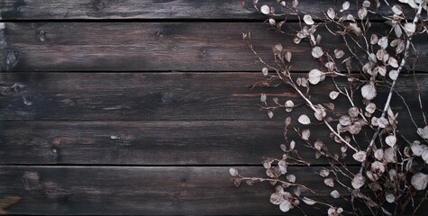 A rustic wooden background with delicate leaves arranged artistically.