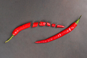 Sliced large red chili served on a black background.
