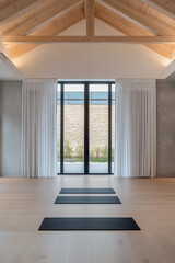 Obraz premium Spacious yoga studio with natural light and serene outdoor view in a modern design