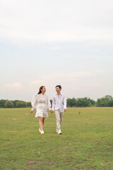 Happy young Asian couple in bride and groom clothing