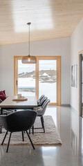 Fototapeta premium Contemporary dining space with mountain view and natural light in a modern home