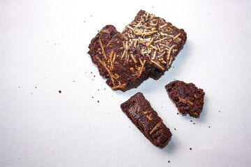 Dry brownies with cheese on white background
