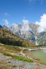 Happo pond, Happo Alpen Line Nature trail, Hakuba, Nagano, Japan, Scenic mountain landscape with hikers