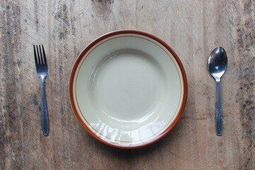 Cutlery 1
Plates and cutlery on wooden background