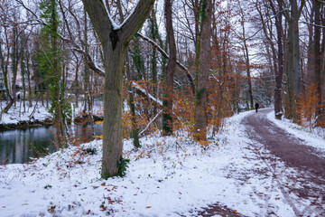 Walking along the Isar Canal in the south of Munich (Bavaria, Germany) in autumn. First snowfall....