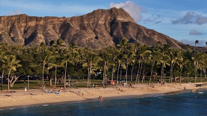 Diamond Head and palm trees behind beach