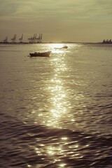 The ocean's mirror reflects the golden hues of the setting sun