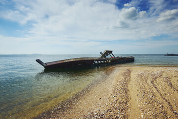 The shipwrecked fishing boat stands as a testament to the relentless power of the sea and the passage of time.