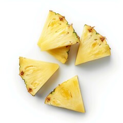 Sliced pineapple pieces resting on white background