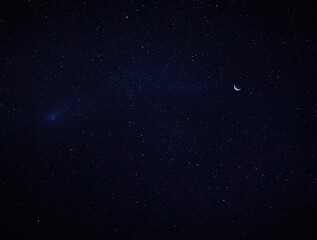 Fototapeta premium Starry night scene with numerous stars, planets, and a crescent moon, galaxy, celestial
