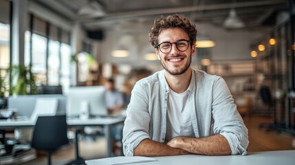 Obraz premium Businessman with a friendly smile seated in a modern office environment emphasizing professionalism and approachability for effective networking