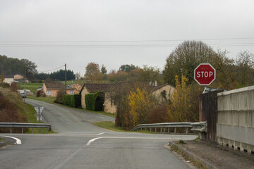 Stop sign at rural intersection in Dordogne France autumn scenery