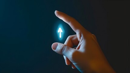 A hand pointing upwards with a glowing arrow symbol against a dark background.