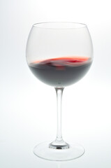 Red wine swaying in a glass / 赤ワインがグラスの中で揺れている
