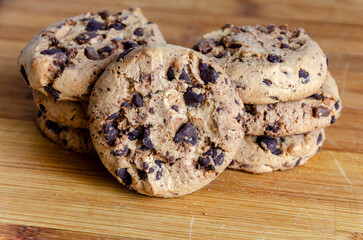 Chocolate chip cookies on a plate with a white background