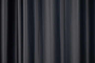 Fototapeta premium The black curtains are wavy, soft, smooth and shiny.