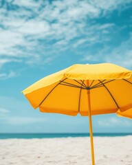 A vibrant yellow beach umbrella stands against a backdrop of blue skies and ocean waves, suggesting a perfect day by the sea.