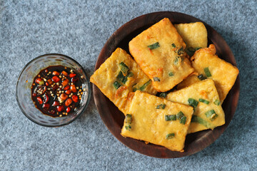 Tempe mendoan is a type of fried food from Indonesian with sweet soy sauce and sliced cayenne pepper