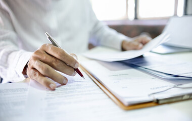 Asian businessman reviewing document reports at office workplace. legal expert, professional lawyer...